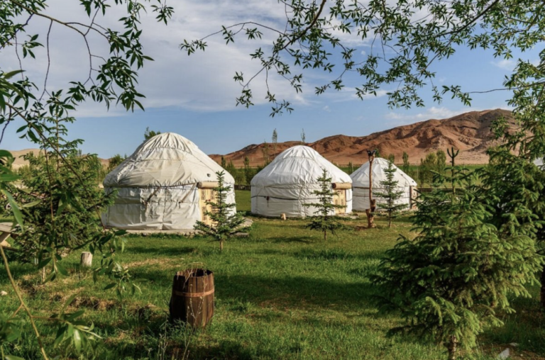 Yurt camp, 3 yurts, mountains in the background