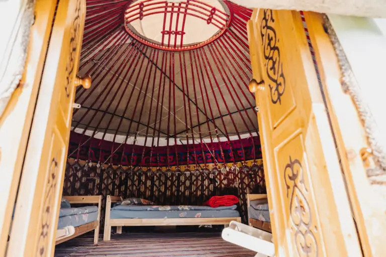 inside of a traditional yurt, doors, bed and ceiling