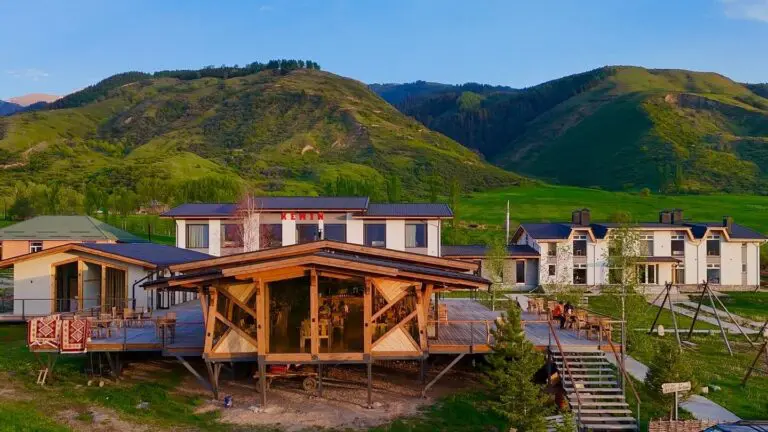 resort buildings with wooden deck in a green mountain valley
