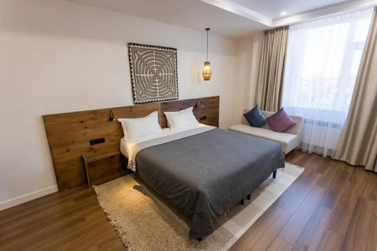 modern hotel room with wooden headboard and large window