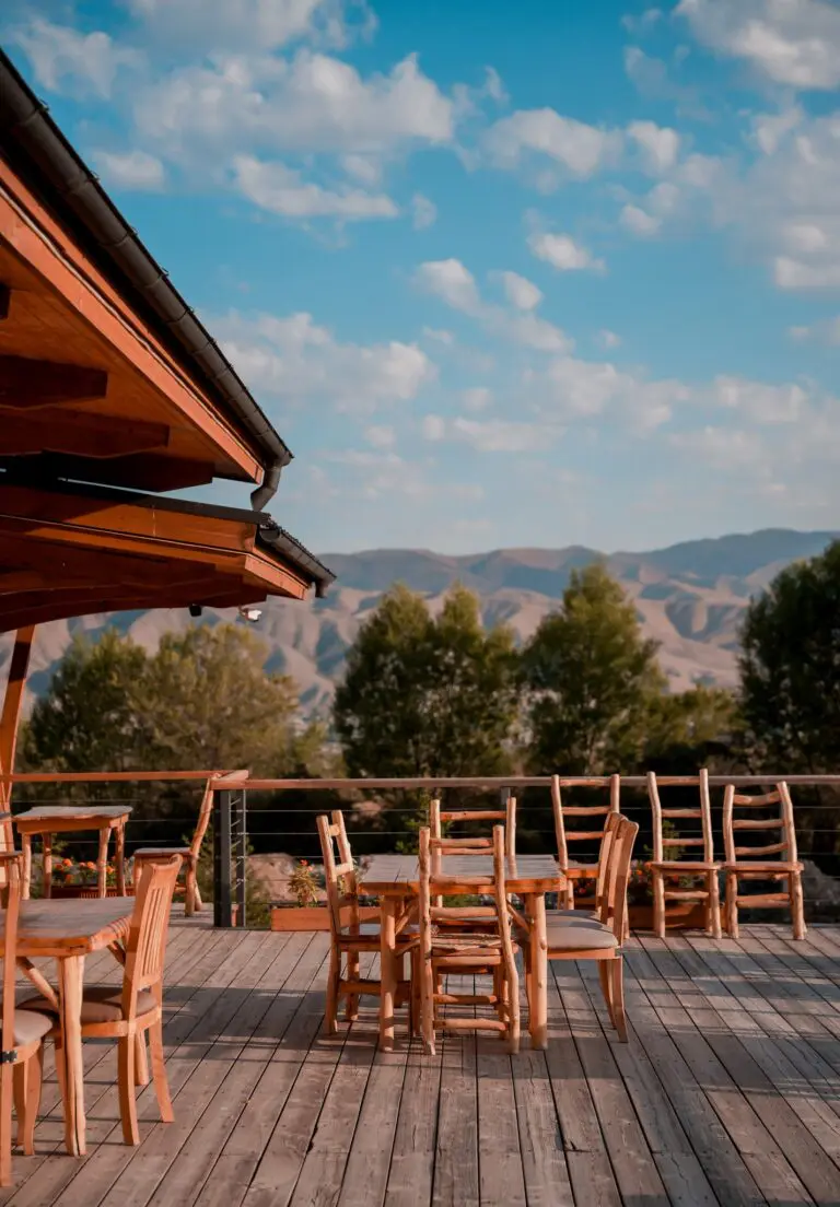 outdoor dining area with wooden furniture and mountain views