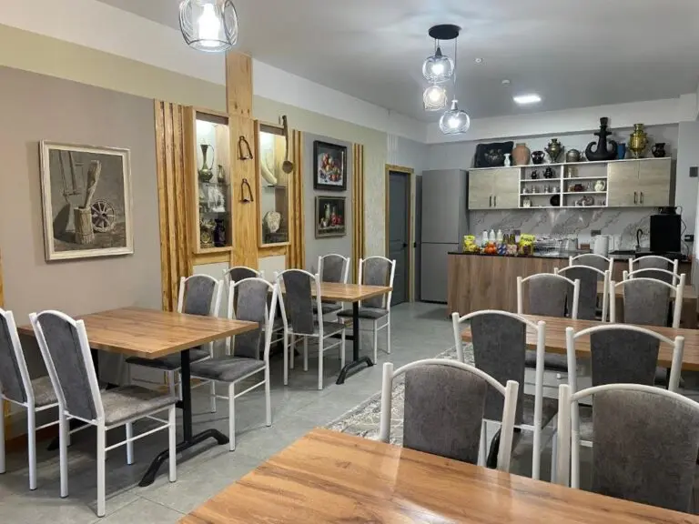 dining area in a guesthouse with wooden tables and chairs