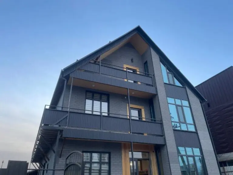 modern guesthouse exterior with balconies and large windows
